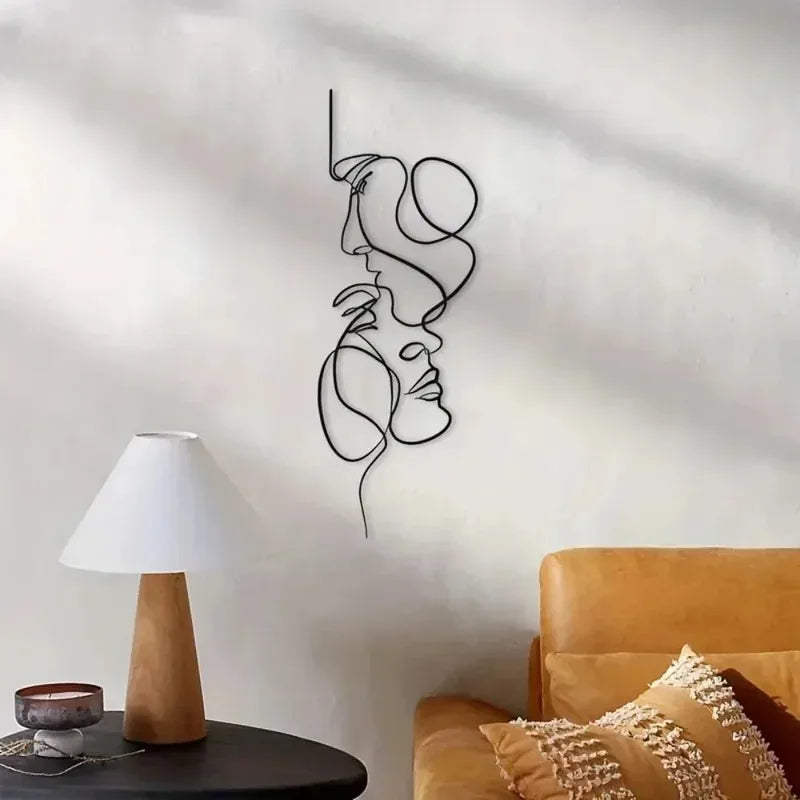Abstract metal line art wall decor on a light wall next to a lamp and sofa