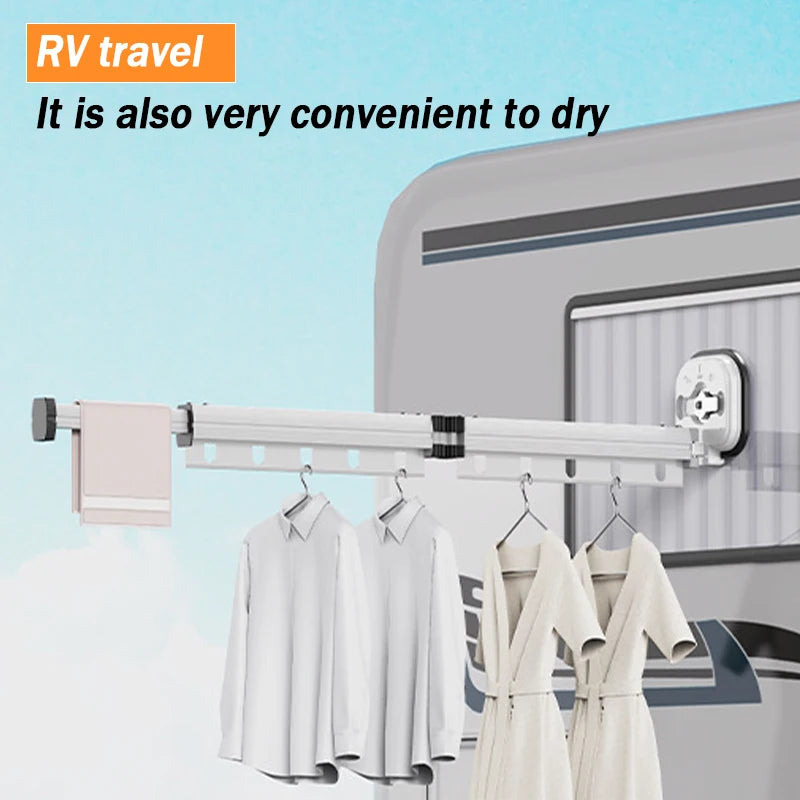 Folding clothes drying rack installed outside on an RV, holding shirts and a towel, suitable for travel use.