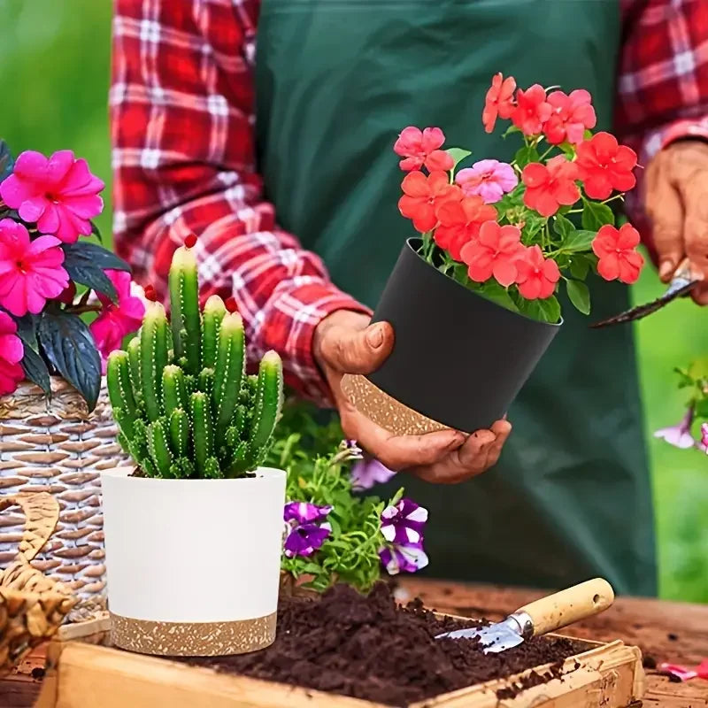 Plastic planters with drainage used for flowering plants and cactus on a garden table