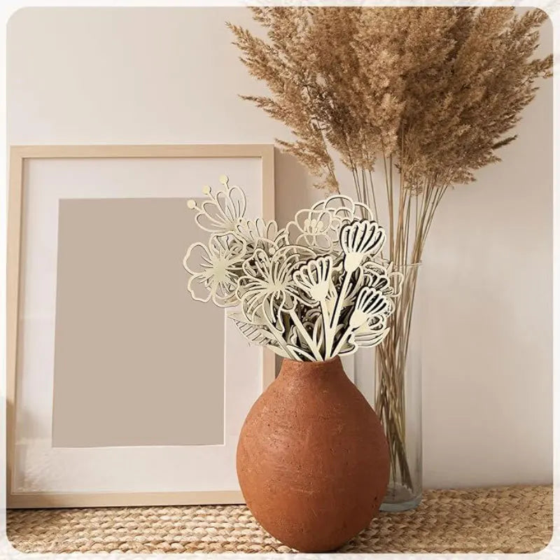 Wildflower wooden floral cutouts styled in a terracotta vase on a home shelf