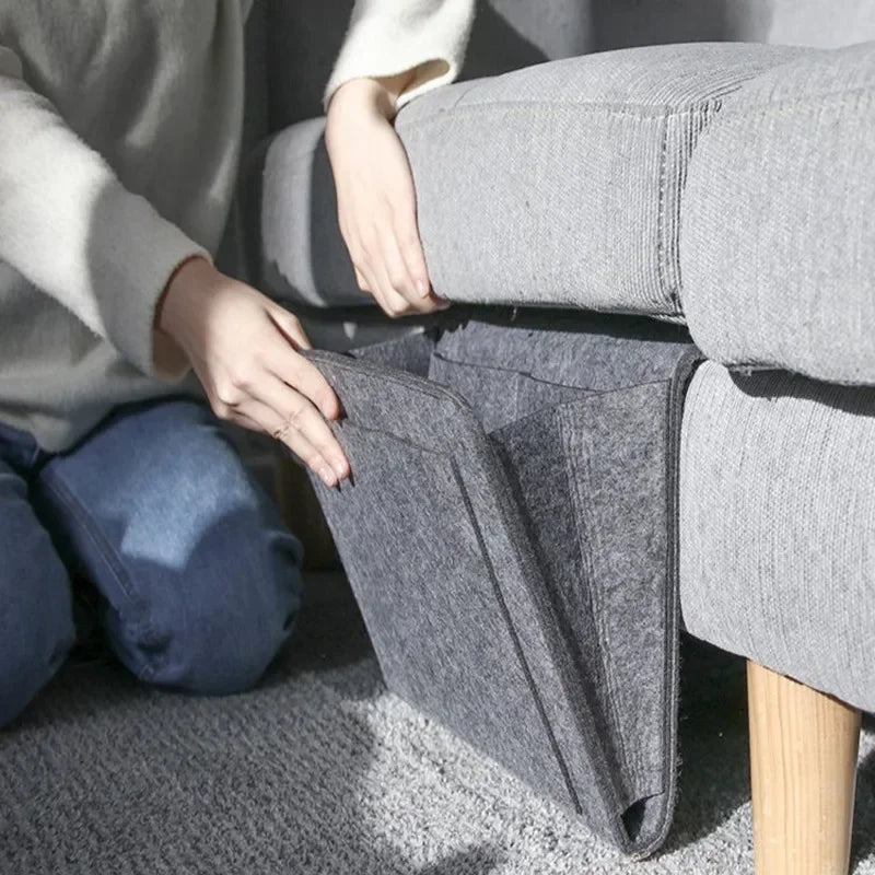 person placing felt organizer under a sofa cushion for easy setup