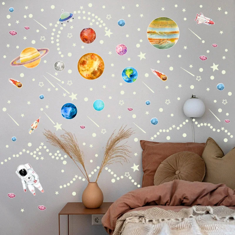 luminous planet and star wall stickers on a beige wall above a bed in a cozy kids room