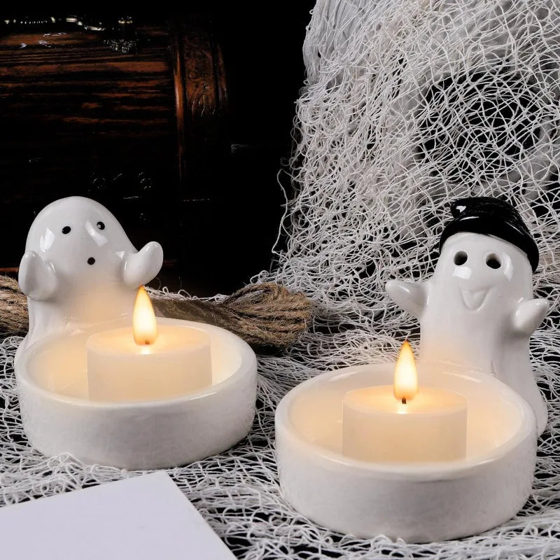 two ceramic ghost candle holders with tea lights, Halloween decor setup