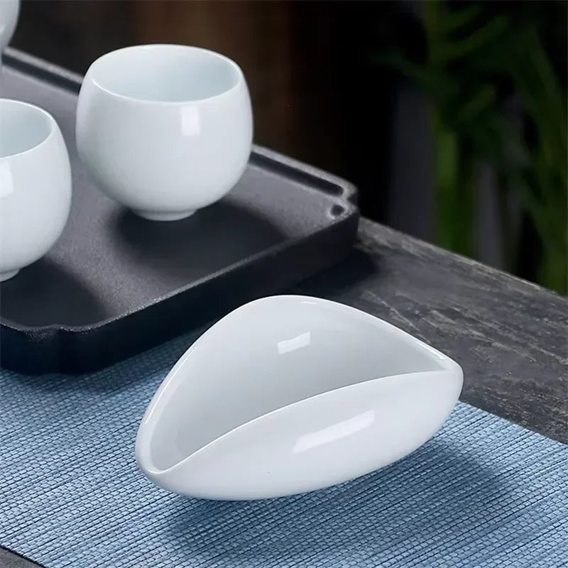 White ceramic coffee tray on a blue placemat next to teacups