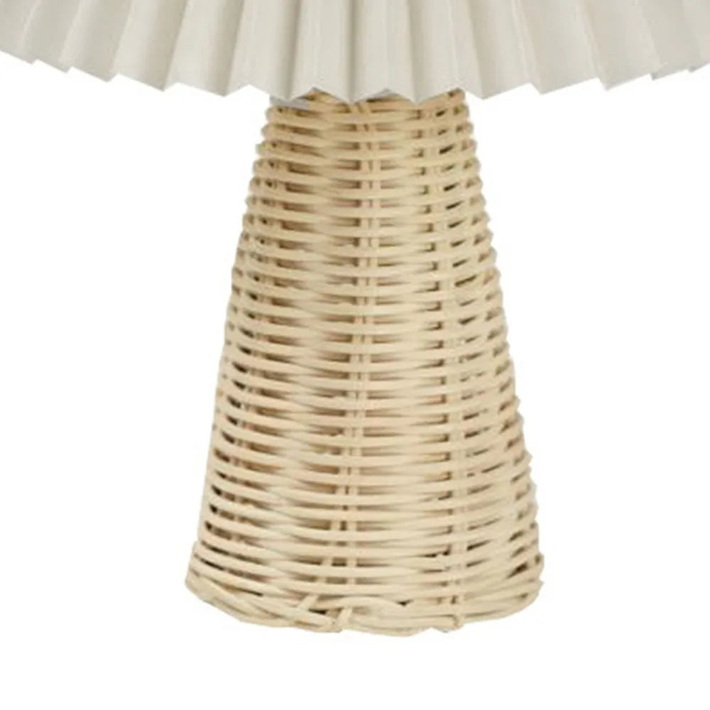 Full view of rattan table lamp base with pleated shade, isolated