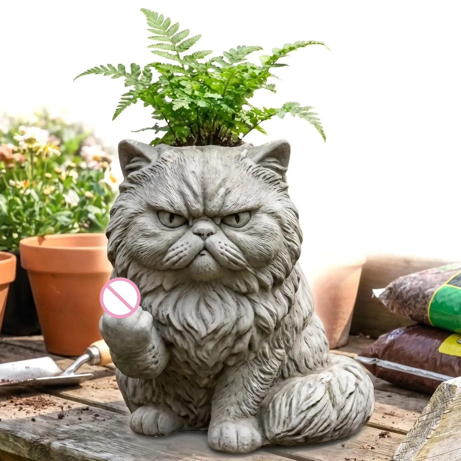 cat planter with fur details and fern plant placed outdoors on a garden table