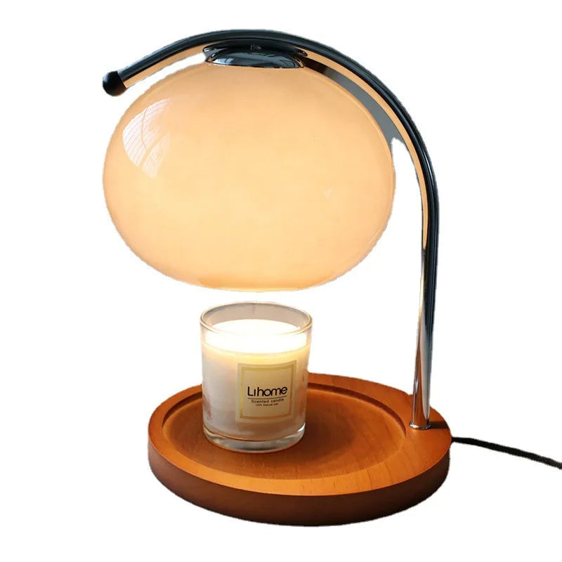 Retro glass candle warmer lamp with milky white shade warming a jar candle on a wood tray base