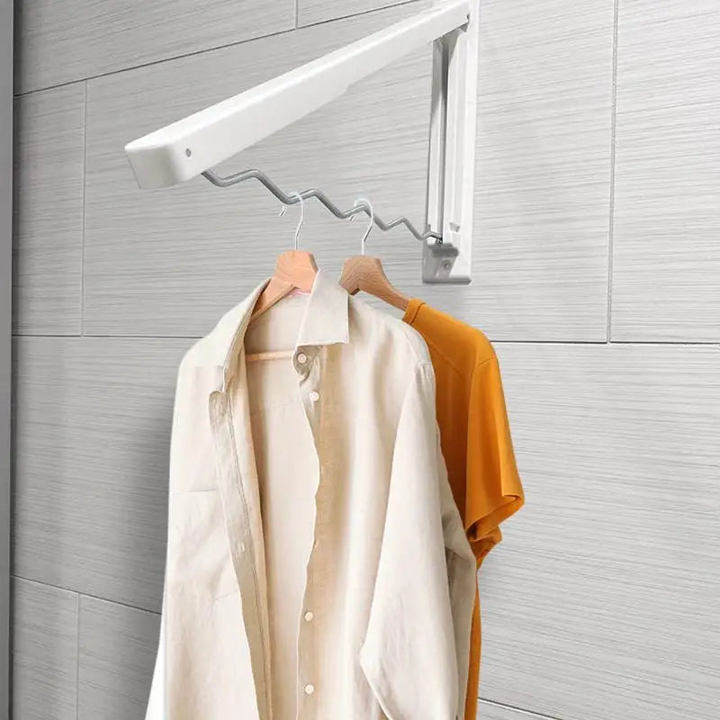 Close-up of wall clothes hanger with shirts in a laundry setup