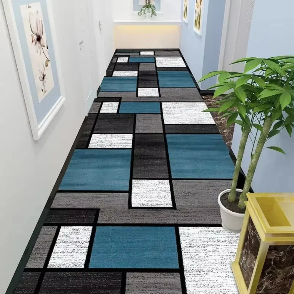 Geometric blue and grey rectangular runner rug in a hallway setting