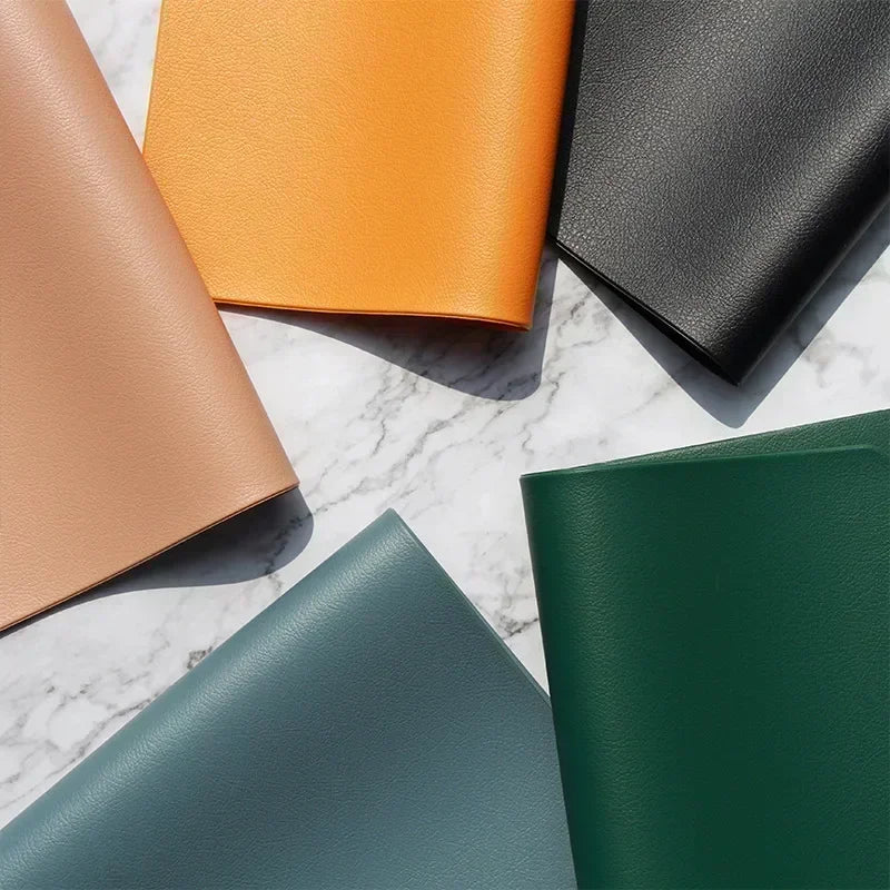 Close-up of several colored PVC placemats in a fan layout showing texture and finish