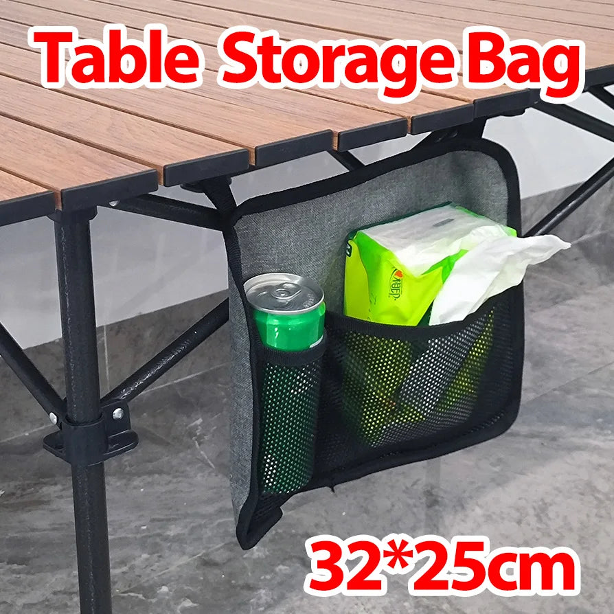 Hanging table storage bag clipped to a folding table holding a can and napkins