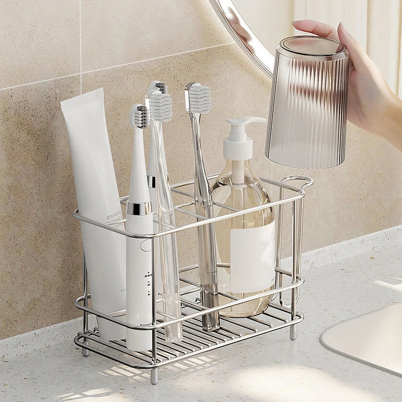 Hand placing a cup onto the stainless steel toothbrush rack beside bathroom essentials