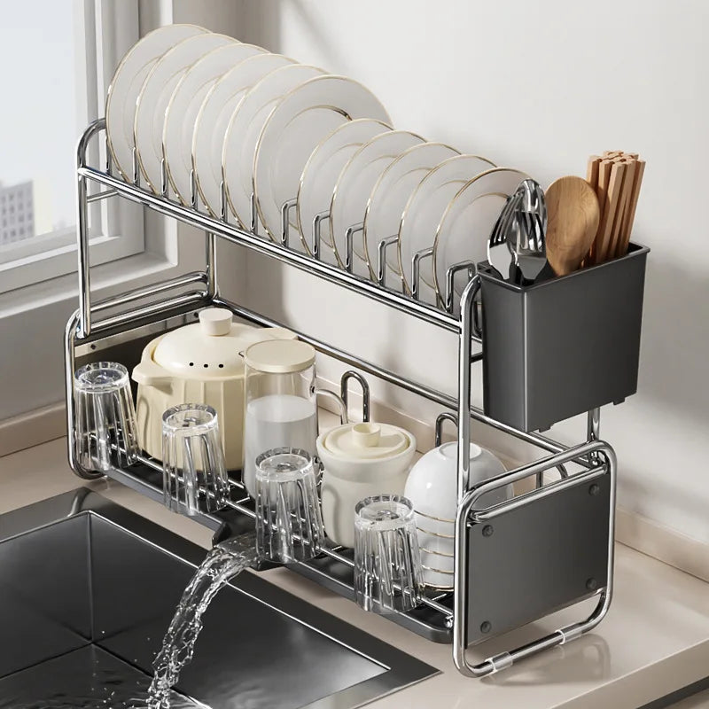 Slim double-layer dish drying rack with utensils, bowls, and mugs, shown draining water into sink