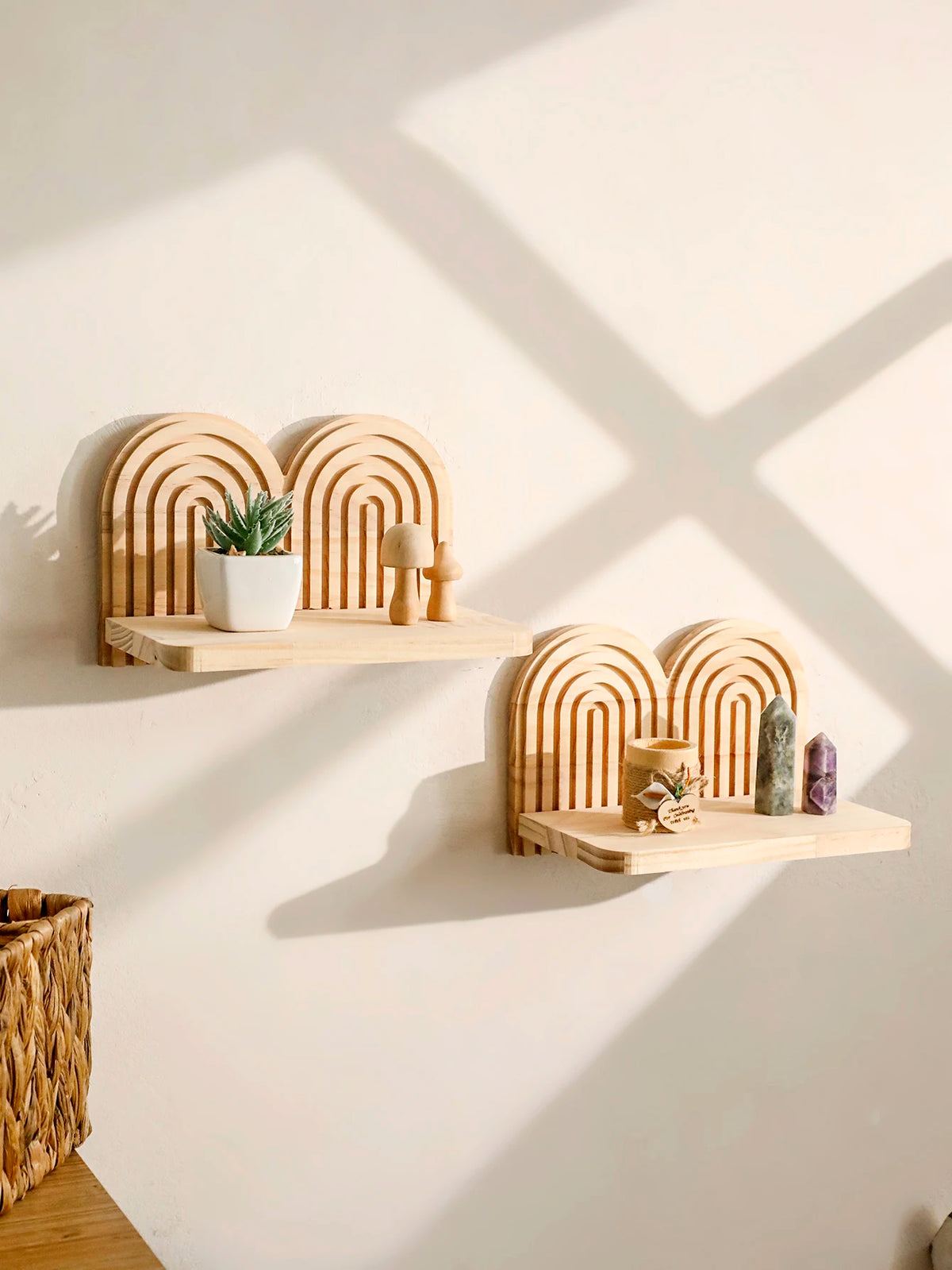 Arched wooden shelves with scalloped rainbow design holding small potted plants, candles, and mushroom decorations