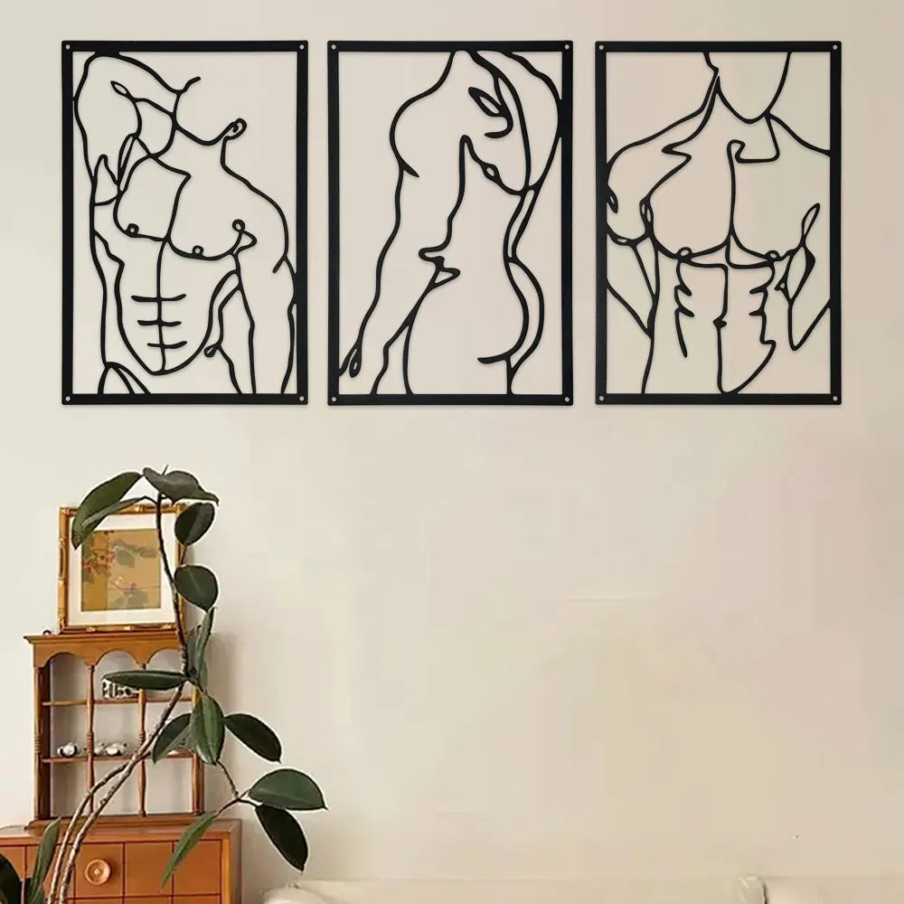 Three abstract black metal line art wall panels featuring figures, styled above a plant shelf