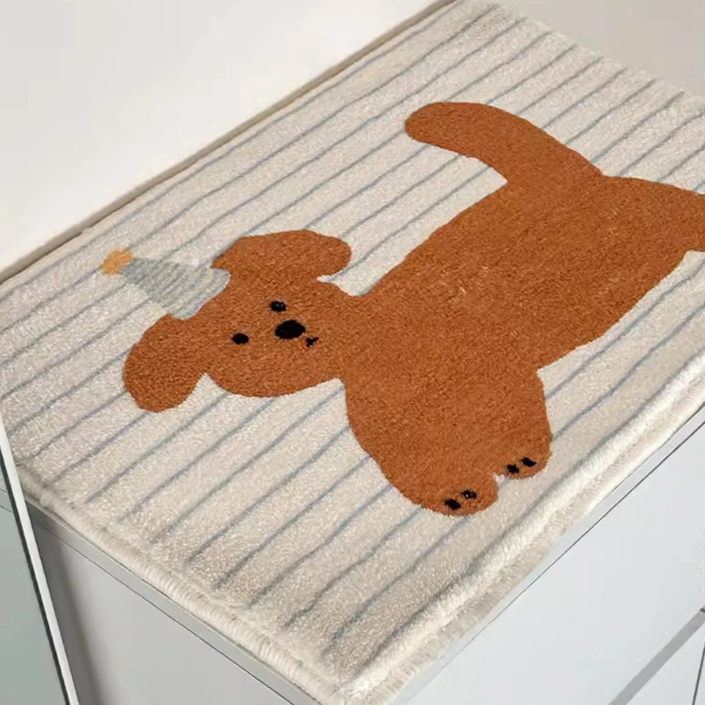 Closeup of puppy print striped bathroom mat on top of a white cabinet