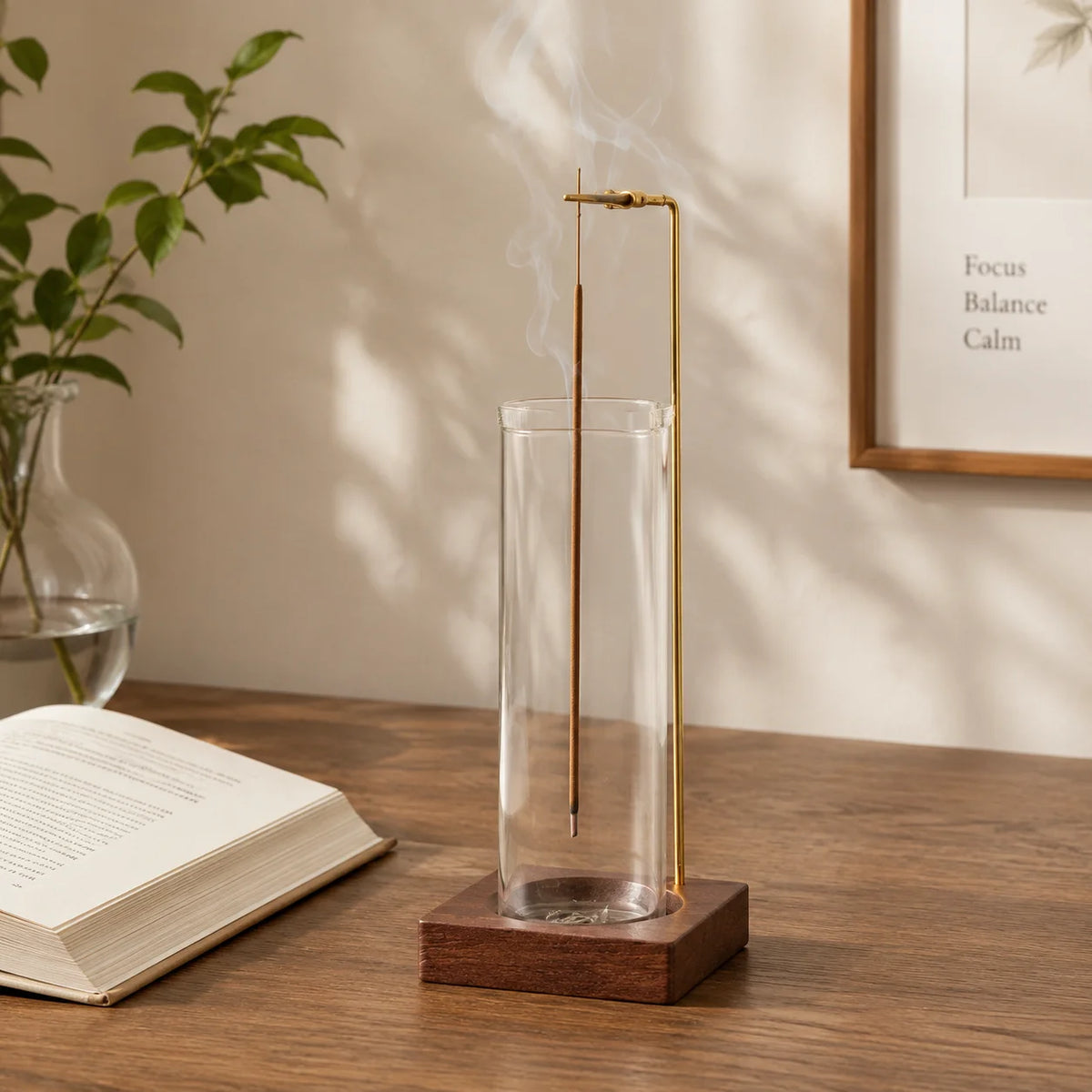 Glass and wood incense holder on desk with book, incense burning for a cozy reading corner