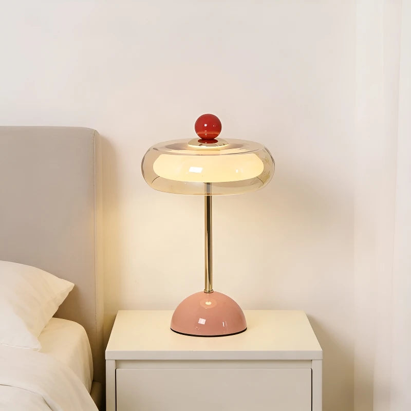 Mushroom table lamp with red accent and pink base on nightstand