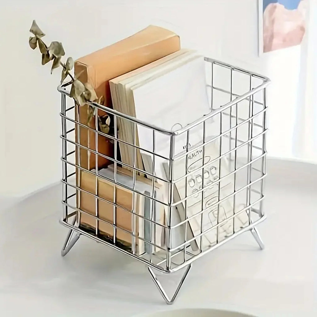 silver metal desktop storage basket holding books and papers on a white surface