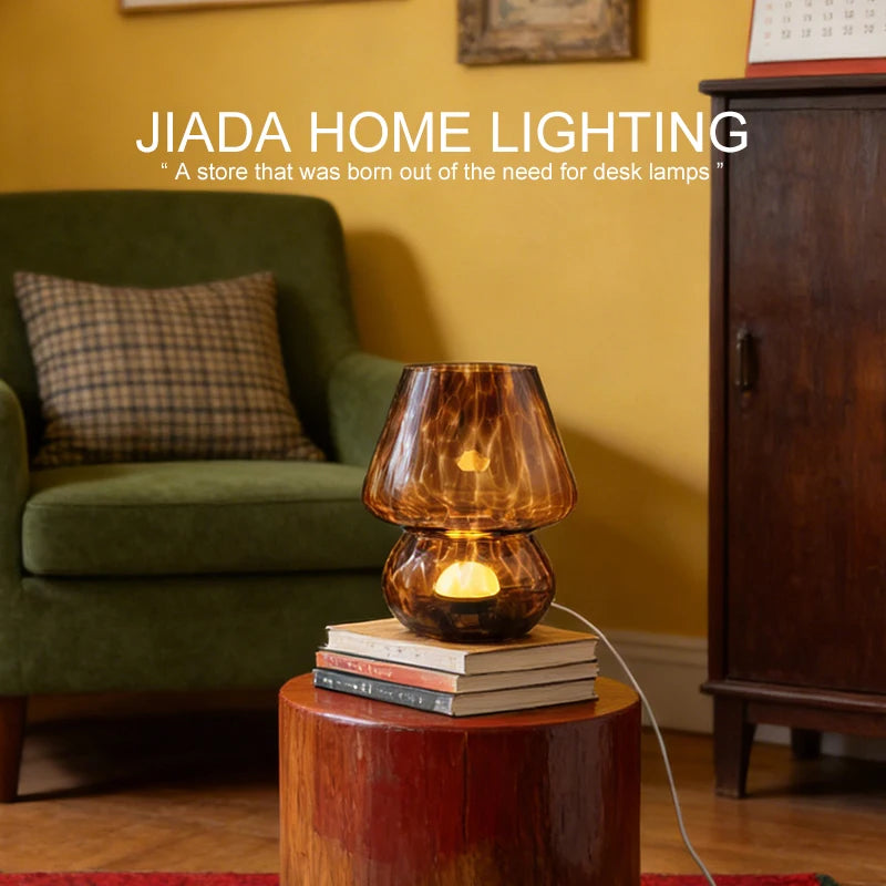 mushroom glass table lamp in coffee tortoise color on a side table by an armchair