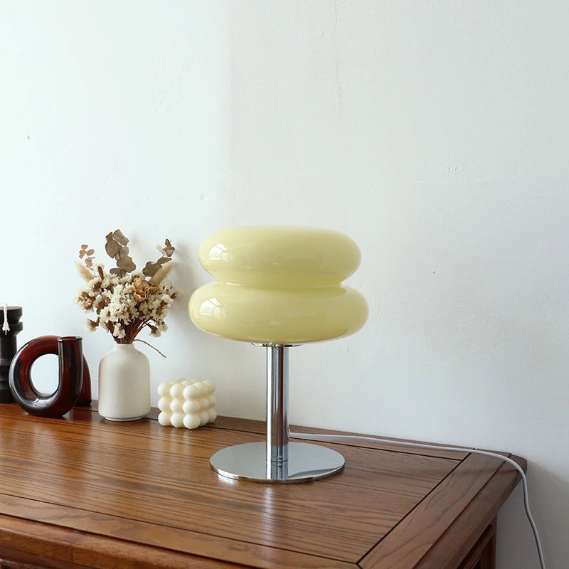 Cream color macaron-style glass table lamp on bedroom furniture