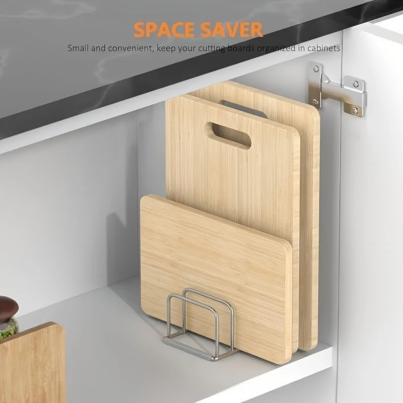 Stainless steel rack organizing cutting boards in a white kitchen cabinet