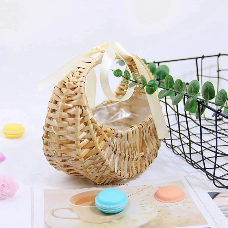 Rattan flower basket with cream bow and greenery, styled on a table with pastel macarons