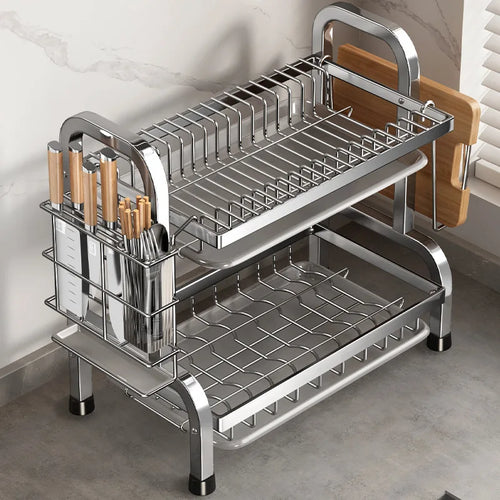 Compact metal dish drying rack with two tiers, utensil holder, and drainboard on a modern kitchen counter