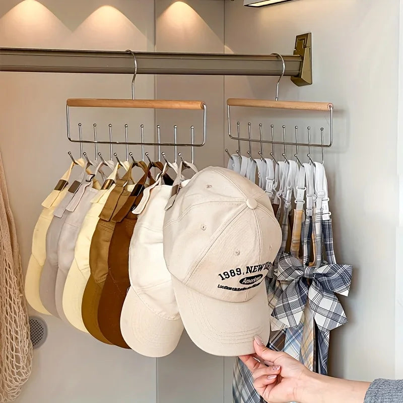 two hanging wooden organizer racks with hooks storing hats and ties on a closet rod