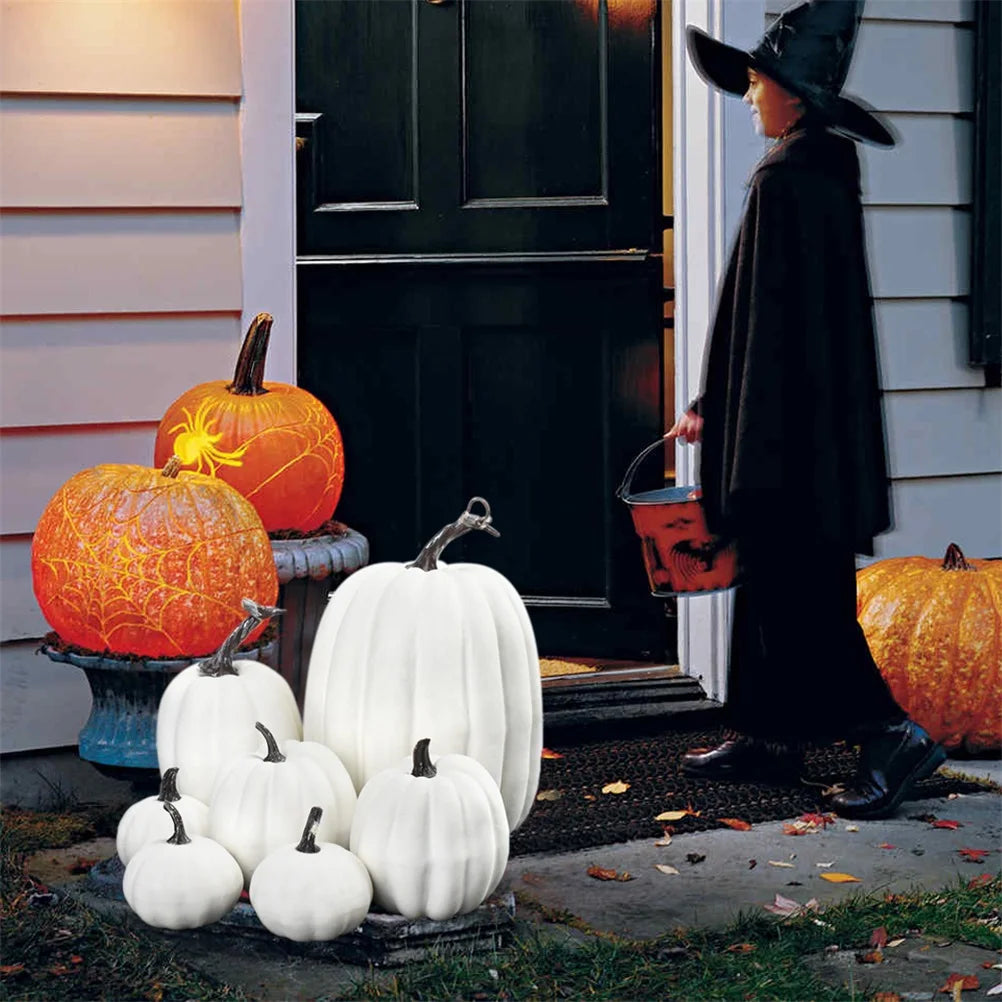 White artificial pumpkin set styled on a doorstep for Halloween with other fall decorations