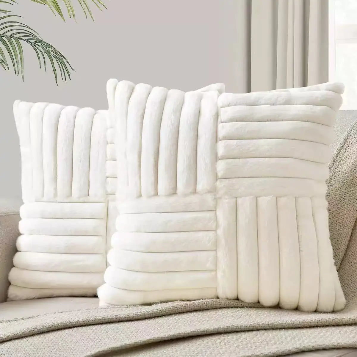 Pair of white plush geometric throw pillow covers styled on a beige sofa