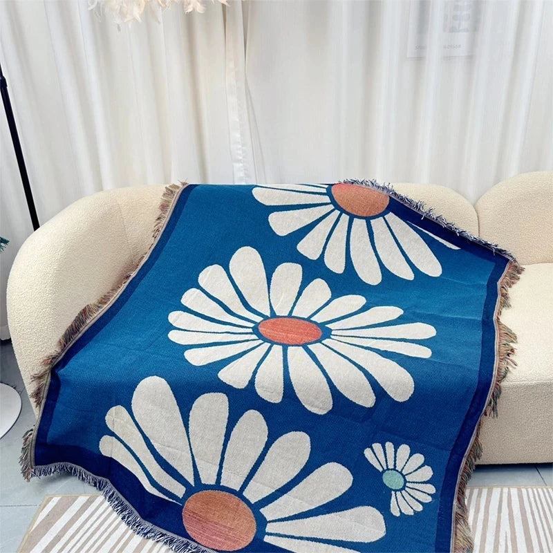 Daisy design blue woven throw blanket on sofa in living room