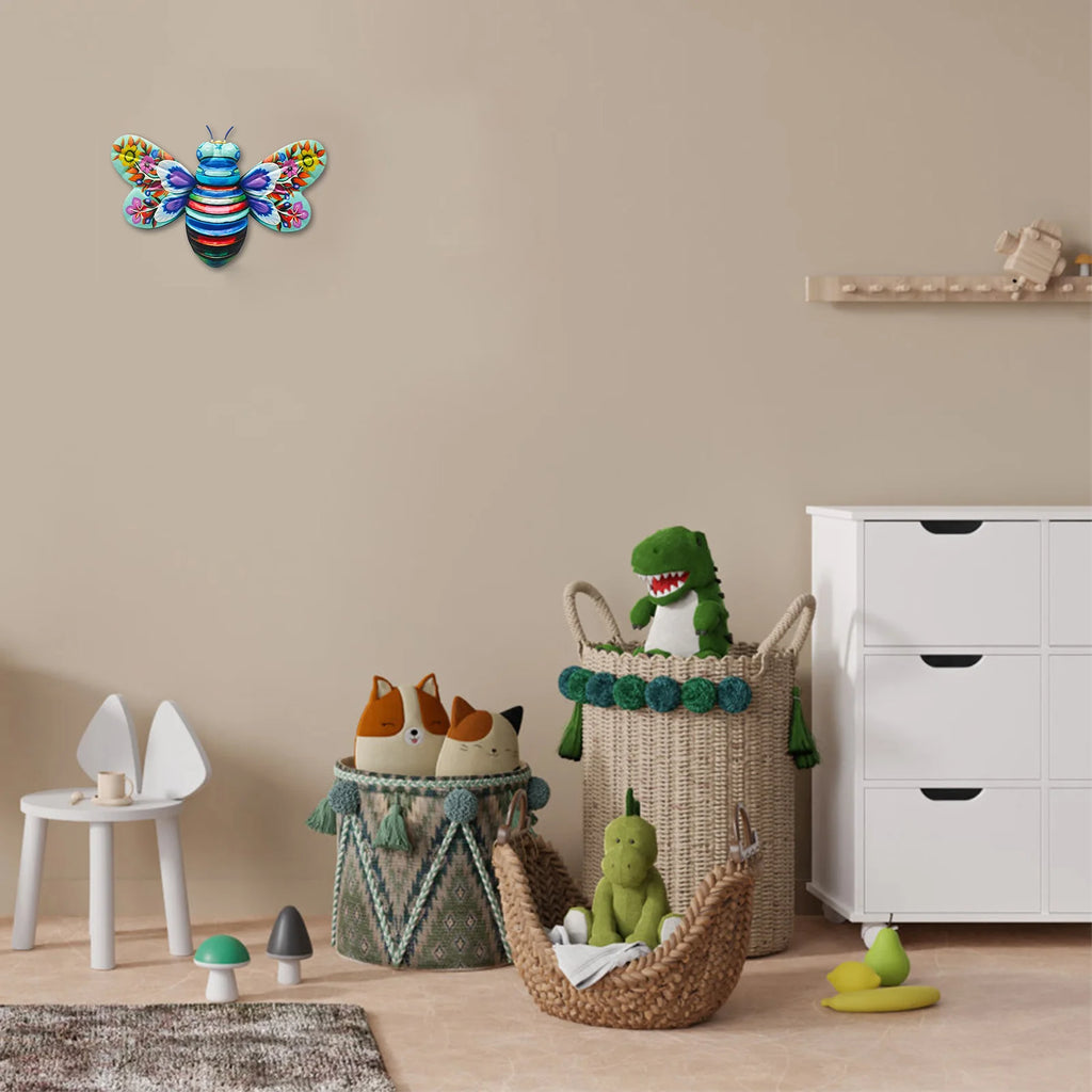 Blue bee wall art hanging above toy baskets in a child's room or play area