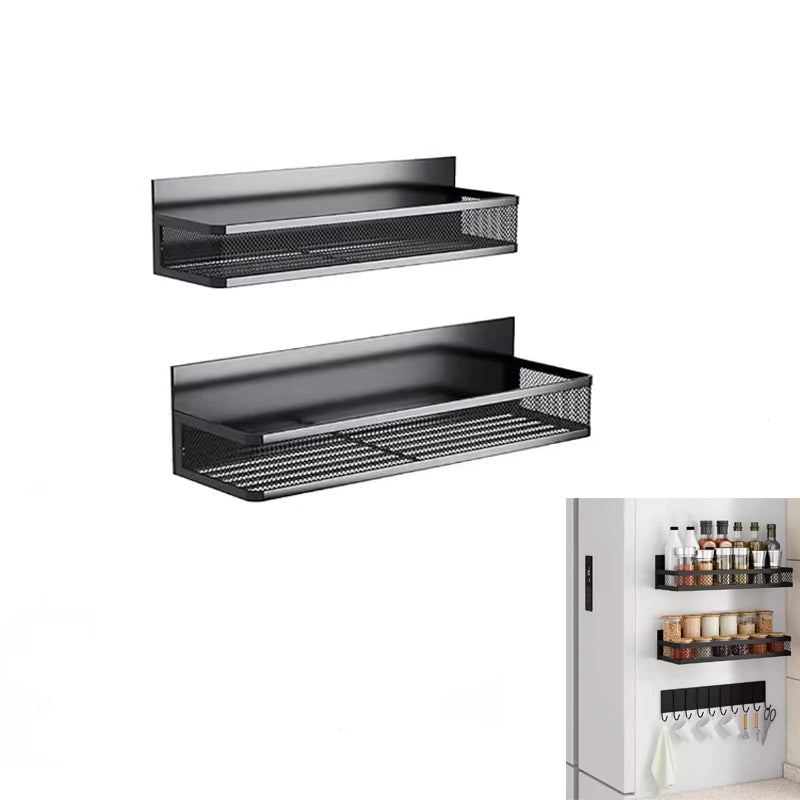 Black metal magnetic spice rack shelves and hooks attached to side of refrigerator, holding spices, condiments, and kitchen utensils