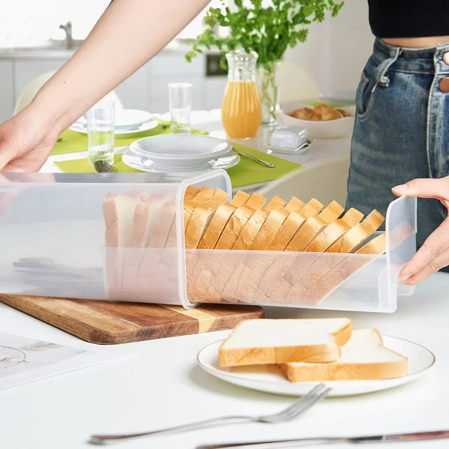 bread loaf neatly stored in transparent container on kitchen counter