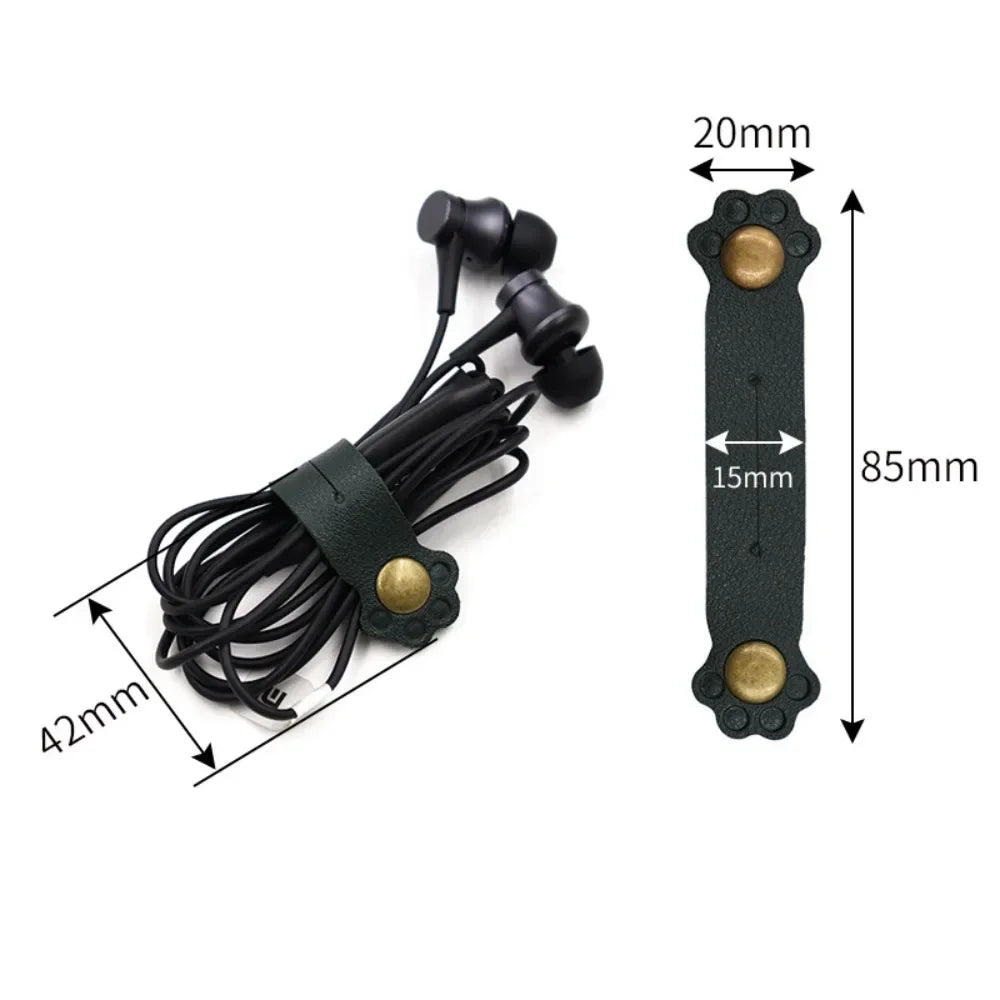 Green leather cat paw cable organizer shown holding earphones; side-by-side with size measurements in millimeters