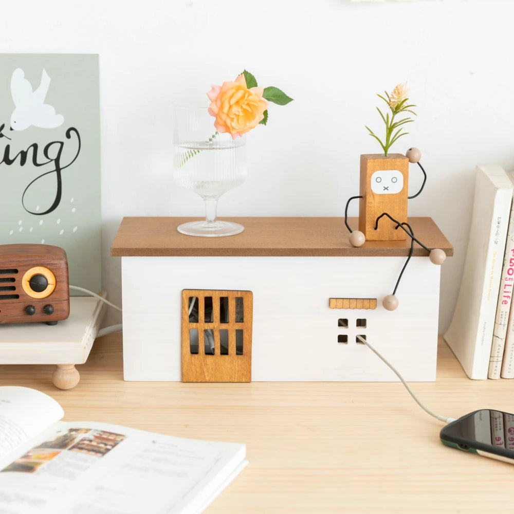 wooden cottage-style cord organizer box on desk with decor on top