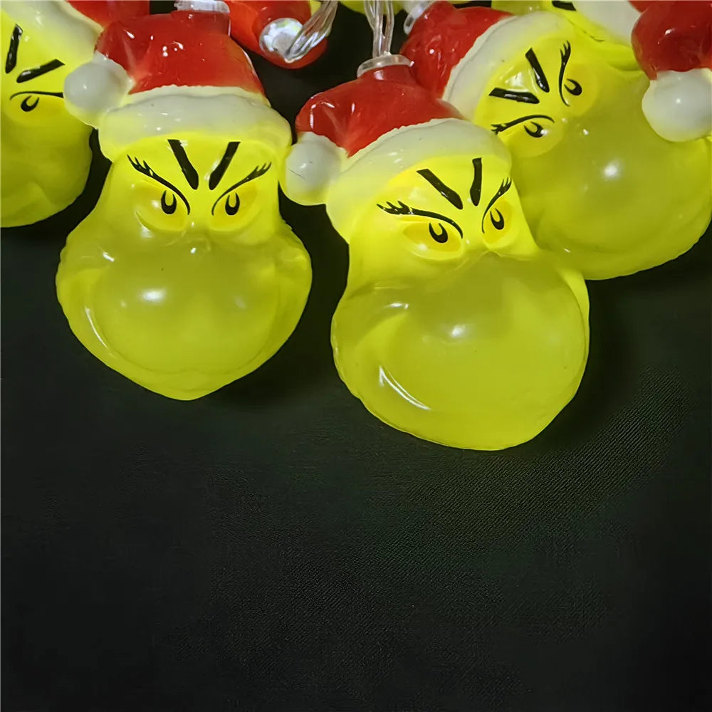 Group of Grinch-themed LED string lights showing face details