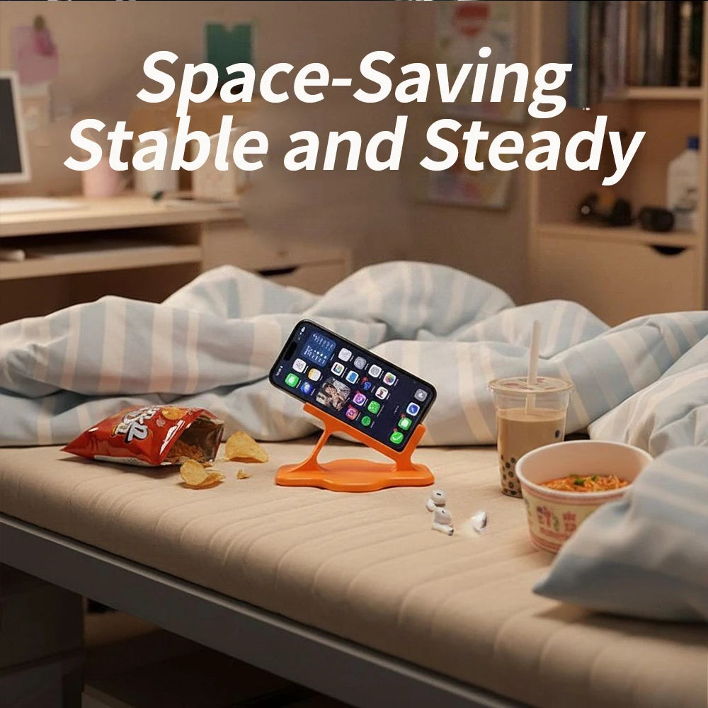 Orange phone holder with smartphone on a bed surrounded by snacks and drinks