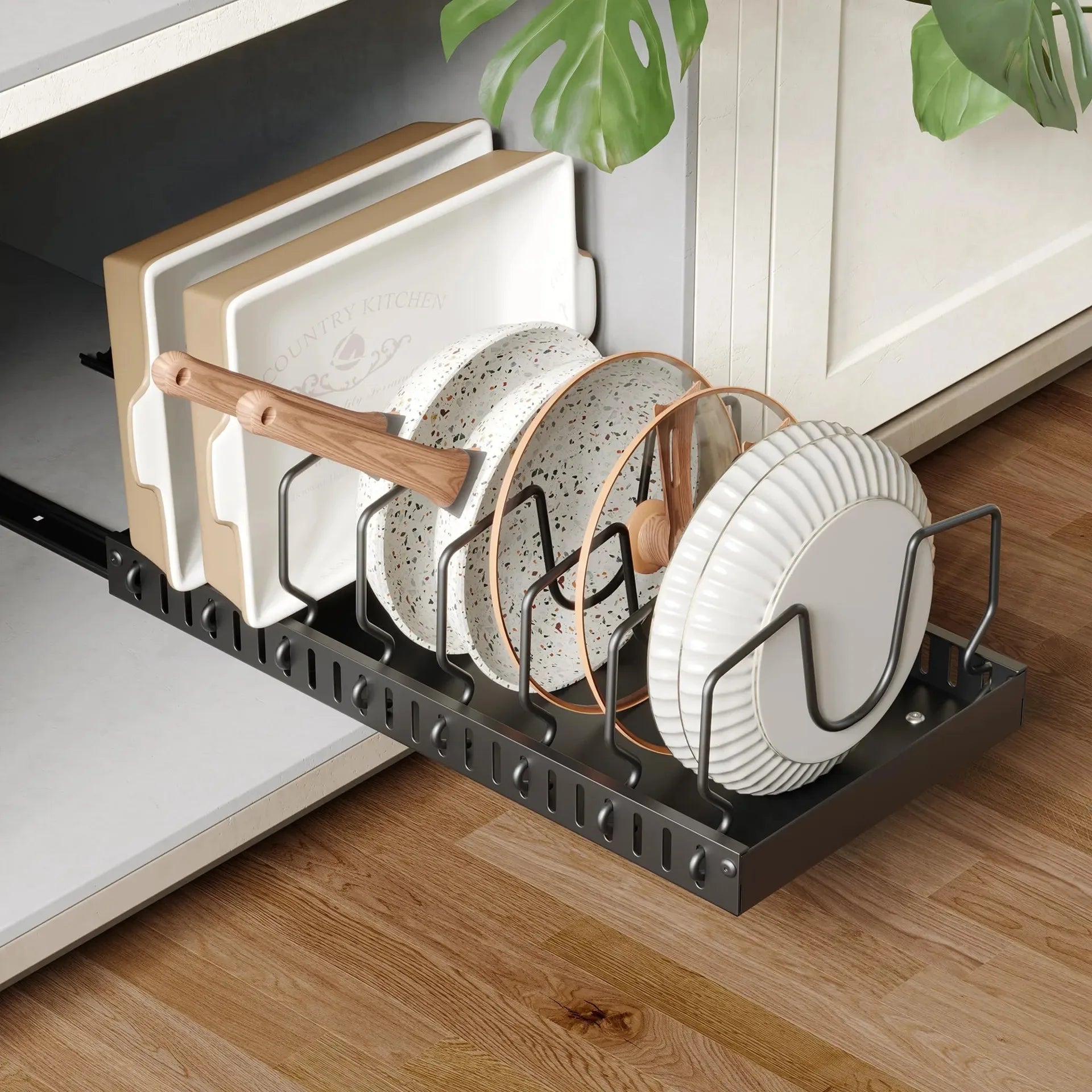 Pull-out kitchen organizer storing plates, cutting boards, and lids in a cabinet