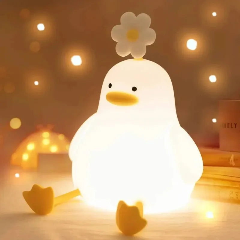 Glowing silicone duck night light with yellow beak and flower detail