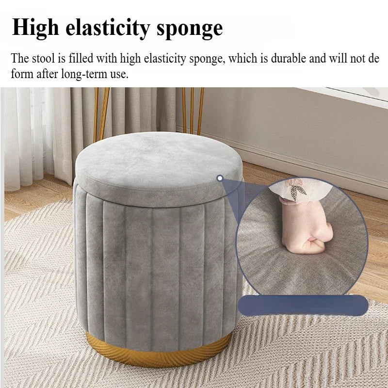 Grey ottoman stool with soft cushioned seat shown by pressing down on the surface