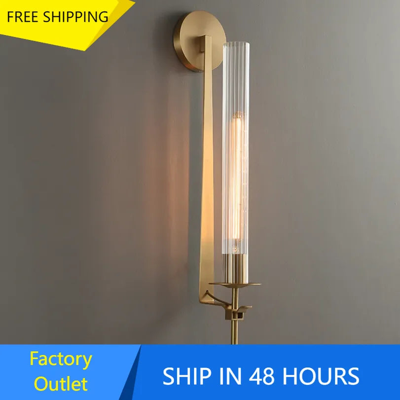 gold vertical ribbed glass wall sconce mounted on wall