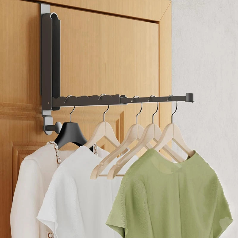 folding over-the-door drying rack holding hangers and clothes in a bedroom or laundry space