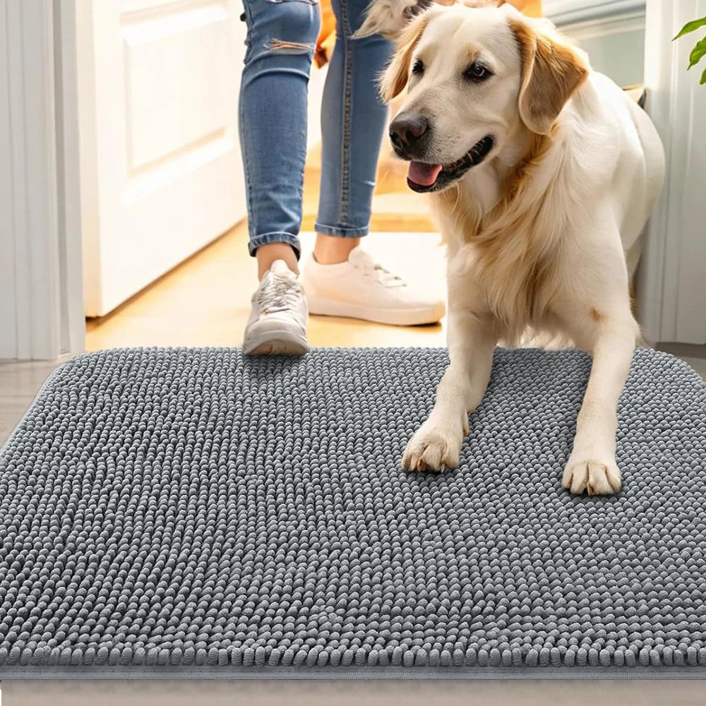 Golden retriever on grey microfiber dog doormat in entryway with owner in background
