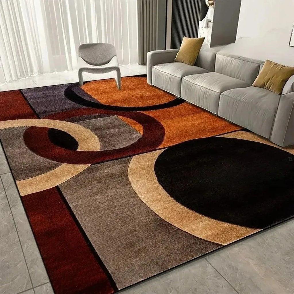 Modern geometric area rug with orange, beige, and black abstract curves in a living room setup