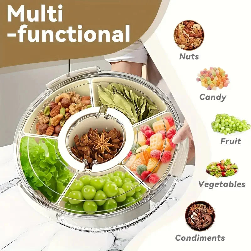 Round snack tray divided into compartments with nuts, candy, fruit, vegetables, and condiments