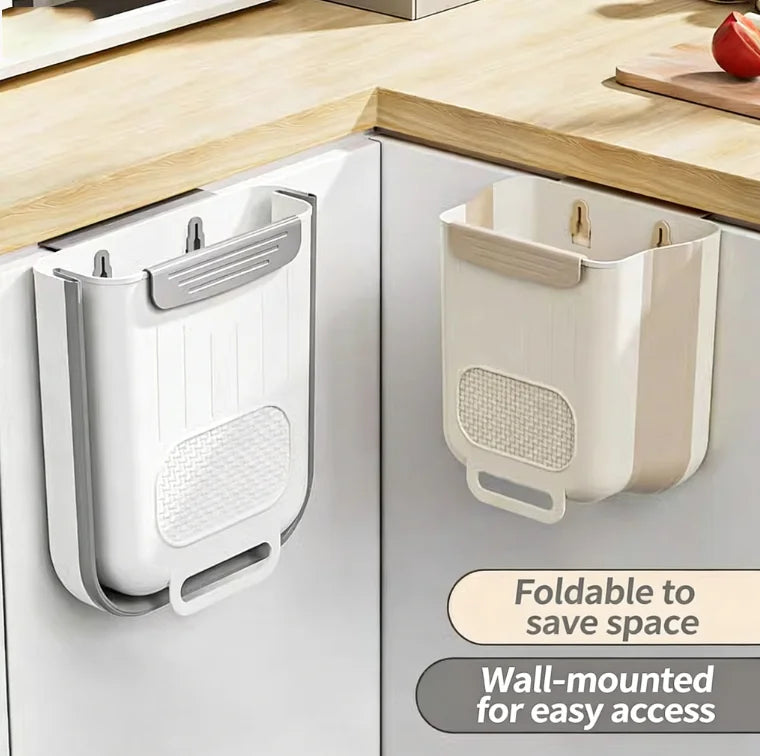 Foldable wall-mounted kitchen trash bins hanging on white cabinet doors, one bin folded and one open