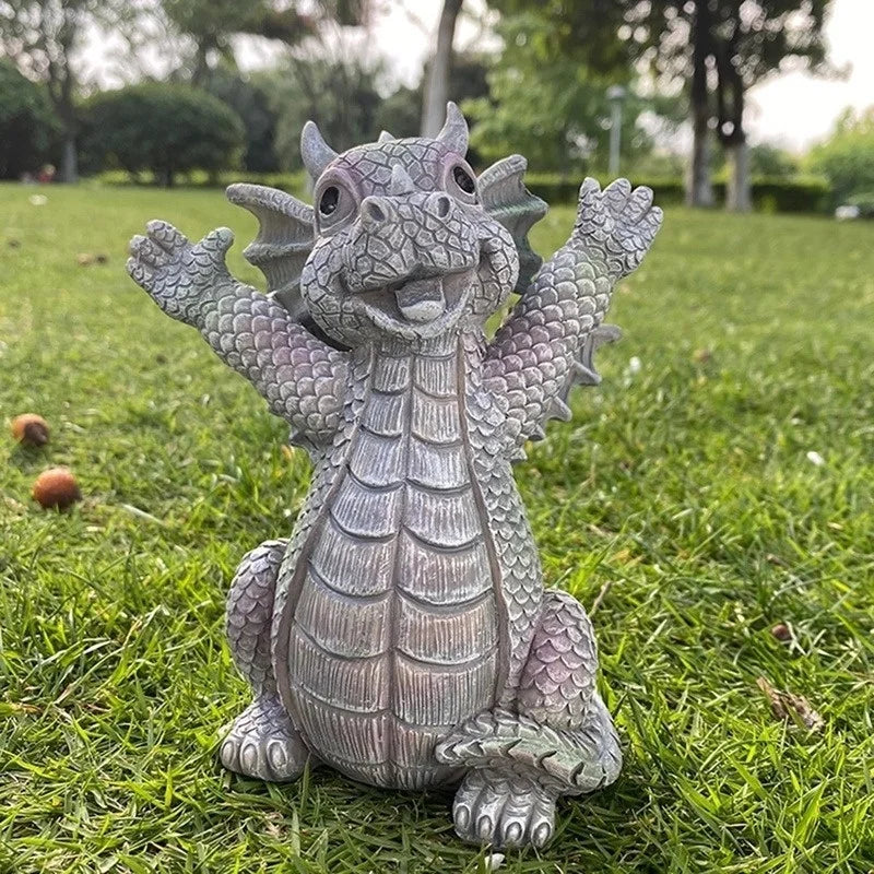 Resin dragon garden statue in playful pose, displayed on green grass outdoors
