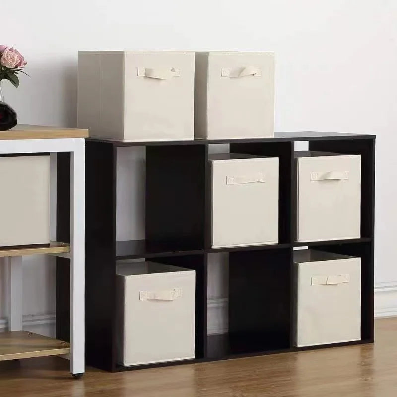 Beige fabric cube bins neatly stored in black and white cube shelving in a living space